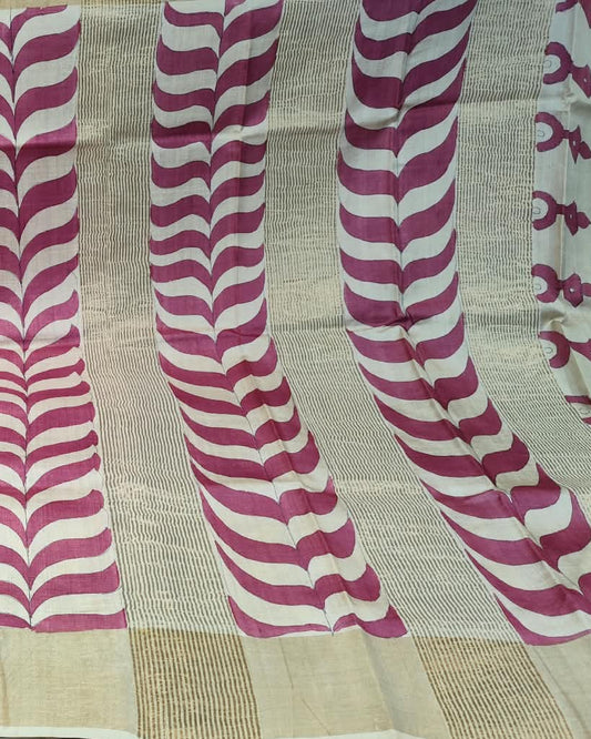 A beige and magenta patterned saree fabric displayed flat, featuring wavy striped motifs and a textured border.