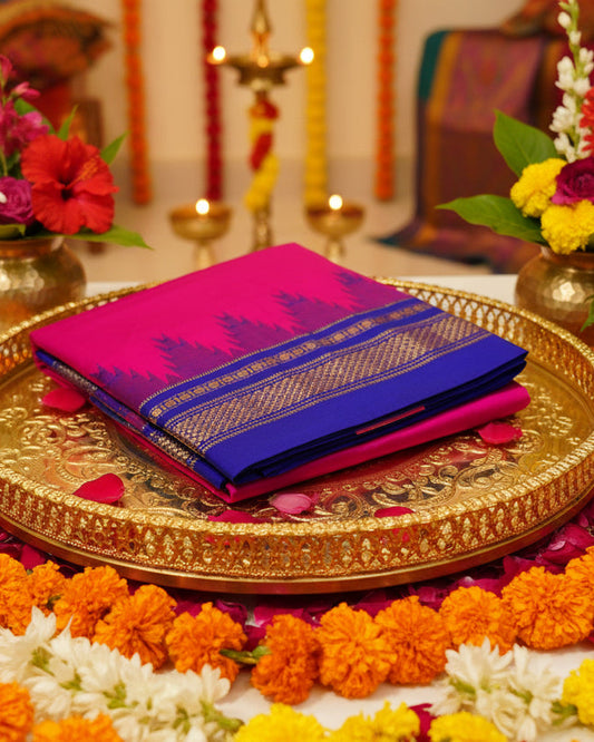Ilkal Silk Saree folded on a gold tray in Hot pink & Blue with gold zari pattern and temple pattern