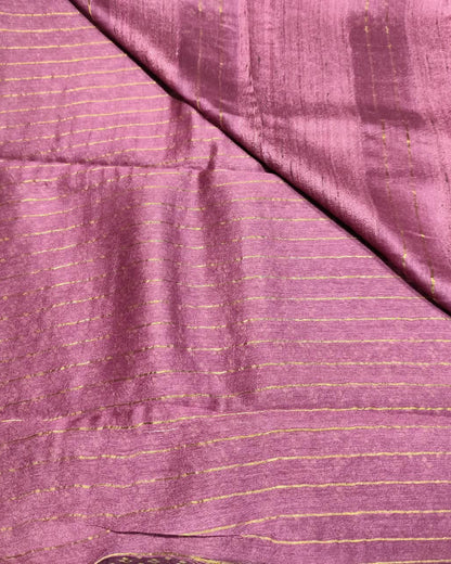 A close-up of a draped Tussar Silk & Digital Printing Pink Saree fabric with fine gold stripes and a subtle sheen.