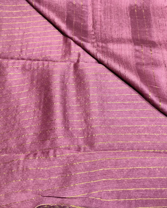 A close-up of a draped Tussar Silk & Digital Printing Pink Saree fabric with fine gold stripes and a subtle sheen.