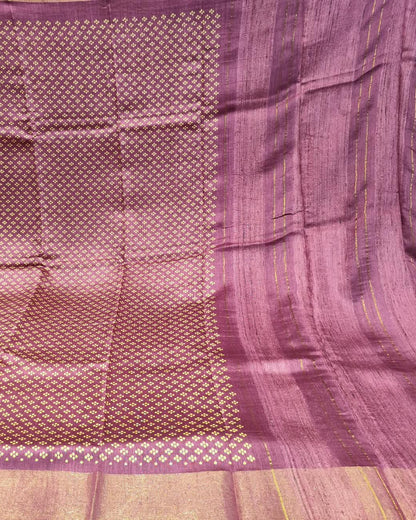 A close-up of a pink and gol Tussar Silk & Digital Printing Pink Saree showing its woven texture, geometric motifs, and striped border.