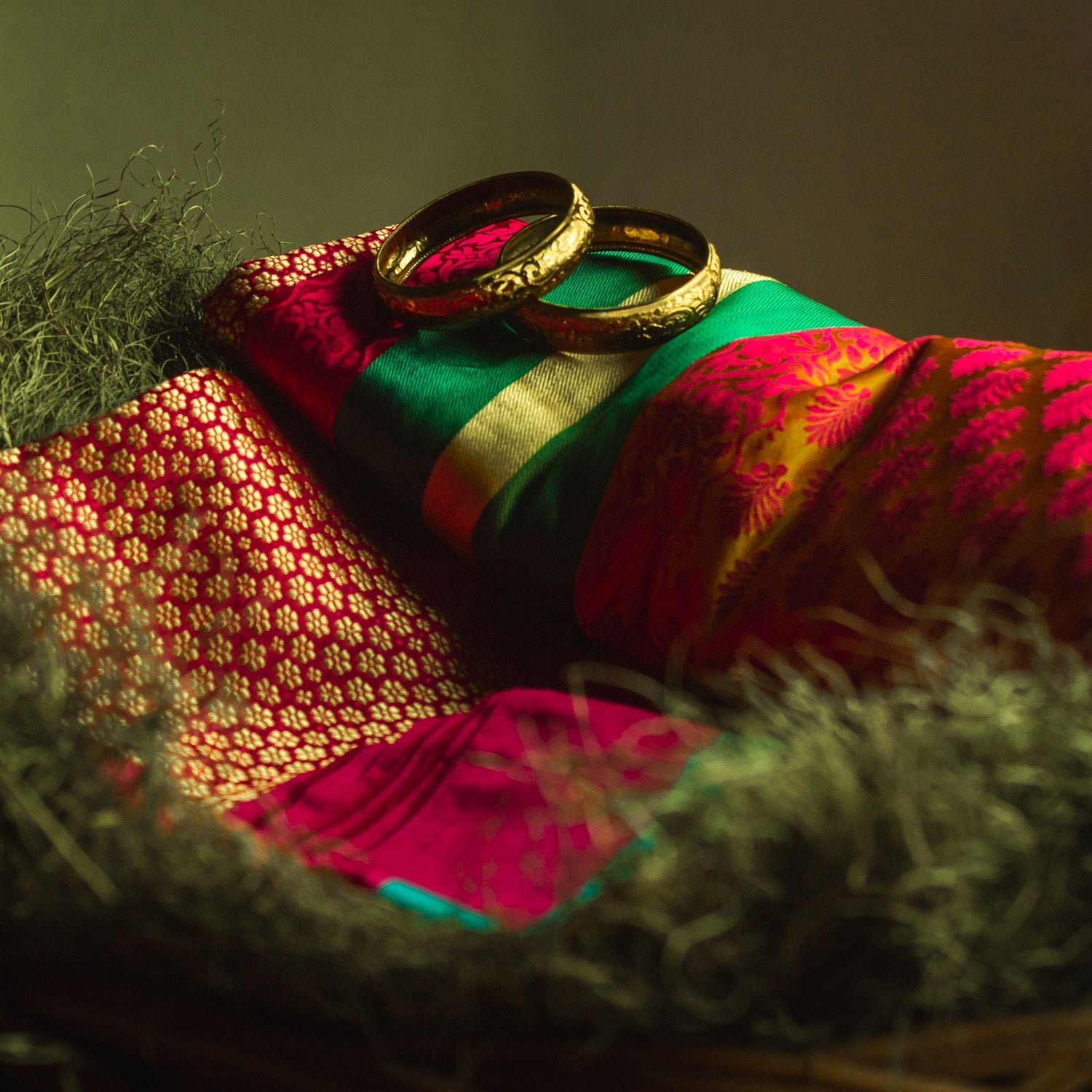 A colorful silk saree in red colour with green border and flower motifs