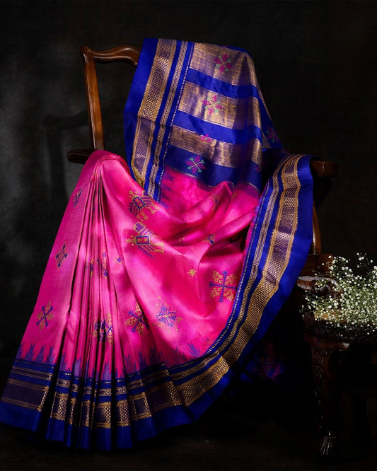 A draped view of Hot Pink Ilkal saree with Blue accents and traditional Indian Kasuti embroidery