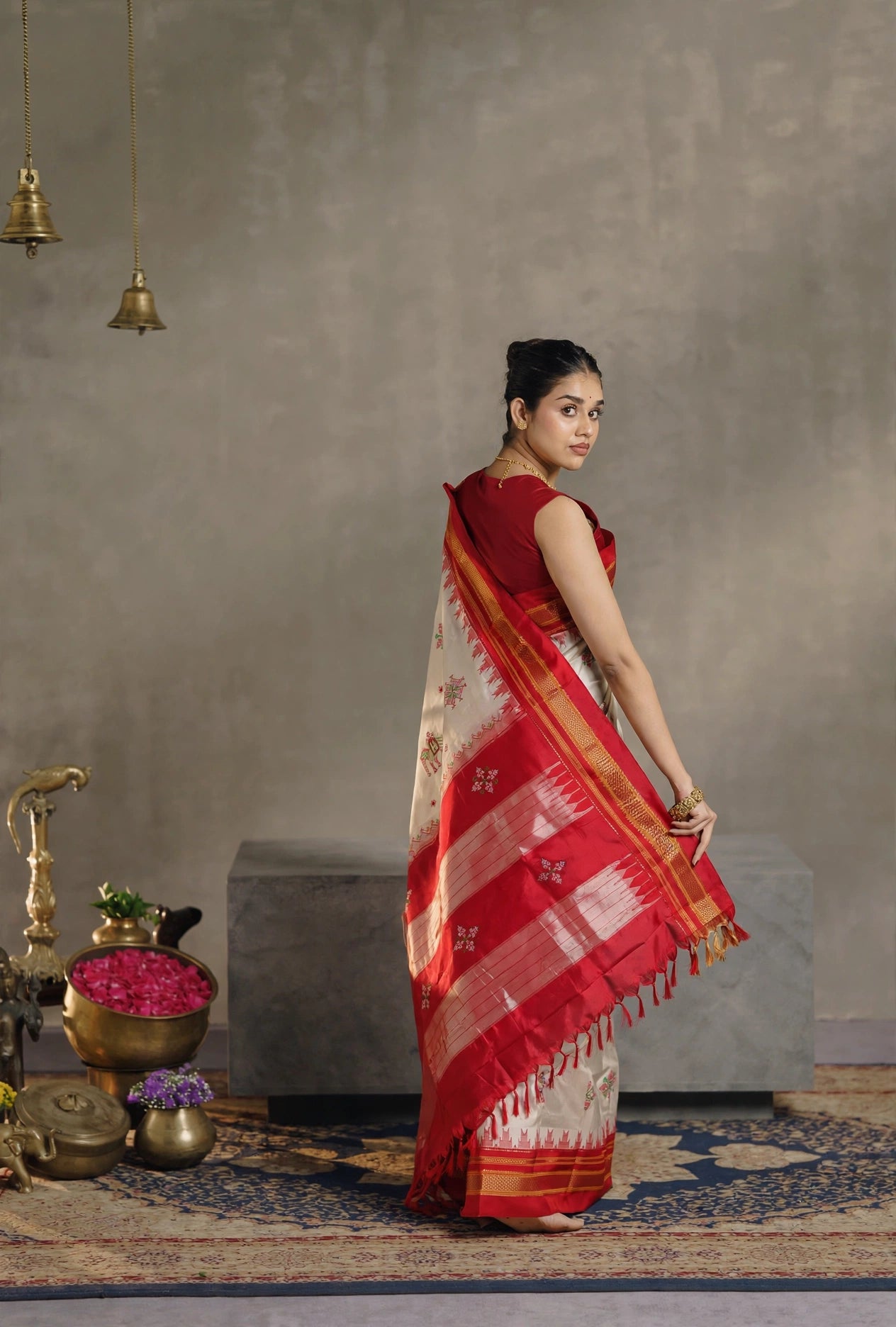 Model wearing Ilkal Silk saree in Off white cream and red with Kasuti inspired motifs